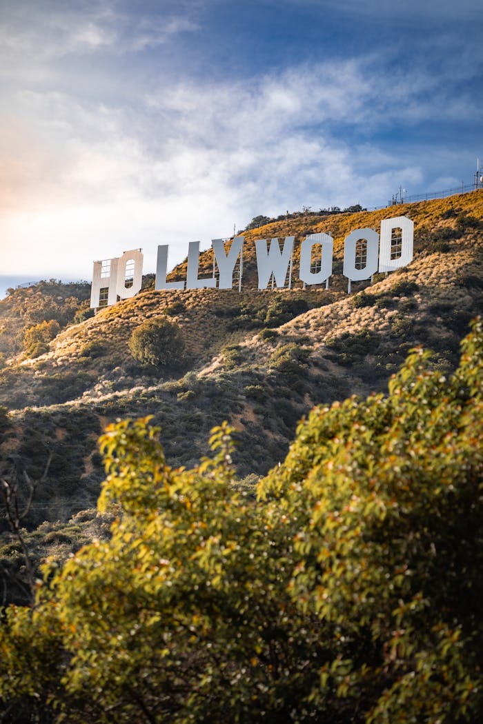 Iconic Hollywood Sign set against the lush hills and clear sky of Los Angeles, California.